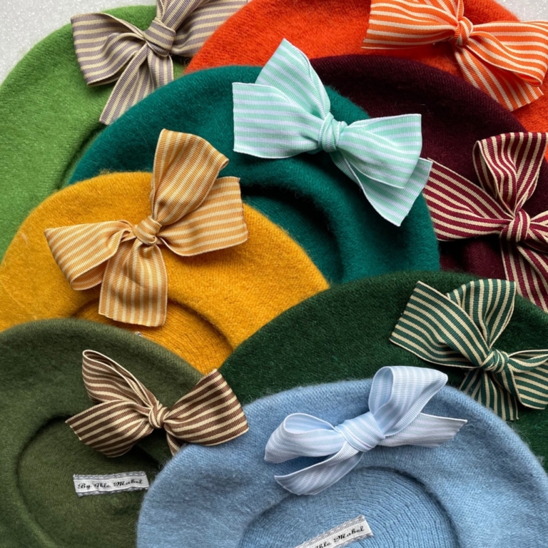 various coloured berets decorated with bows, by Able Mabel