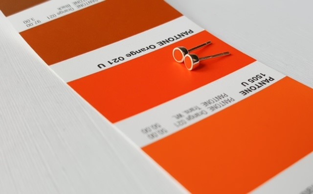 Colour Design - orange dot earrings on orange pantone strip