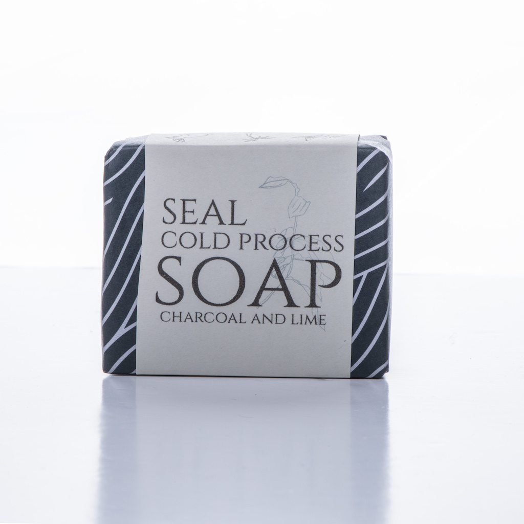 Wrapped soap with wrapper saying Seal cold process soap - charcoal and lime