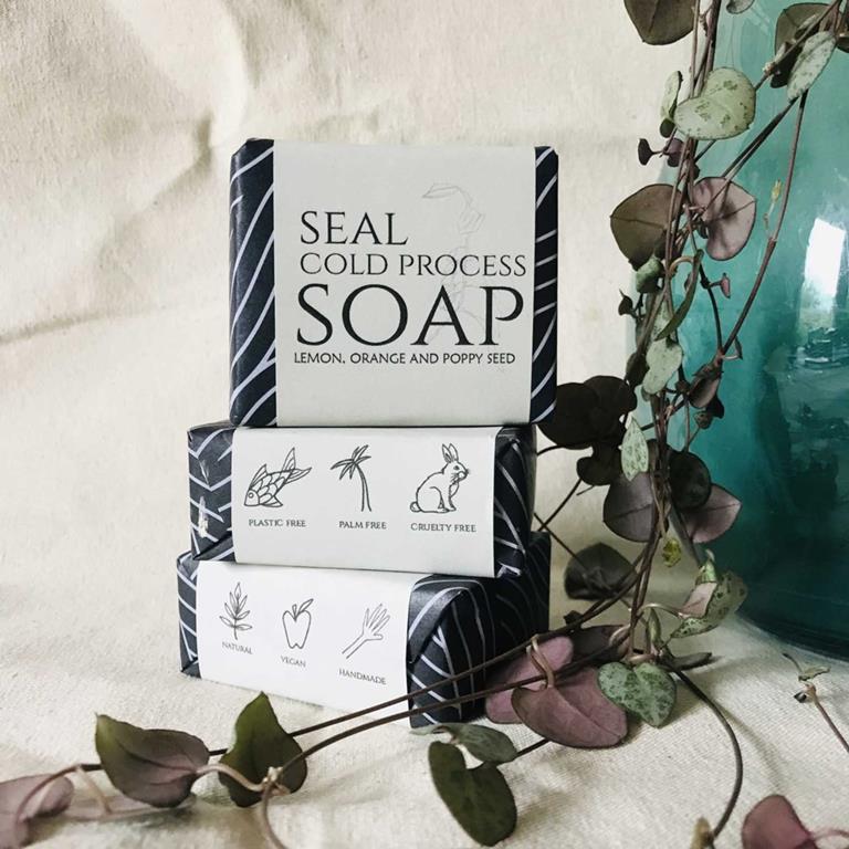 Selection of wrapped Seal brand hand made cold pressed soaps - lemon, orange and poppy seed