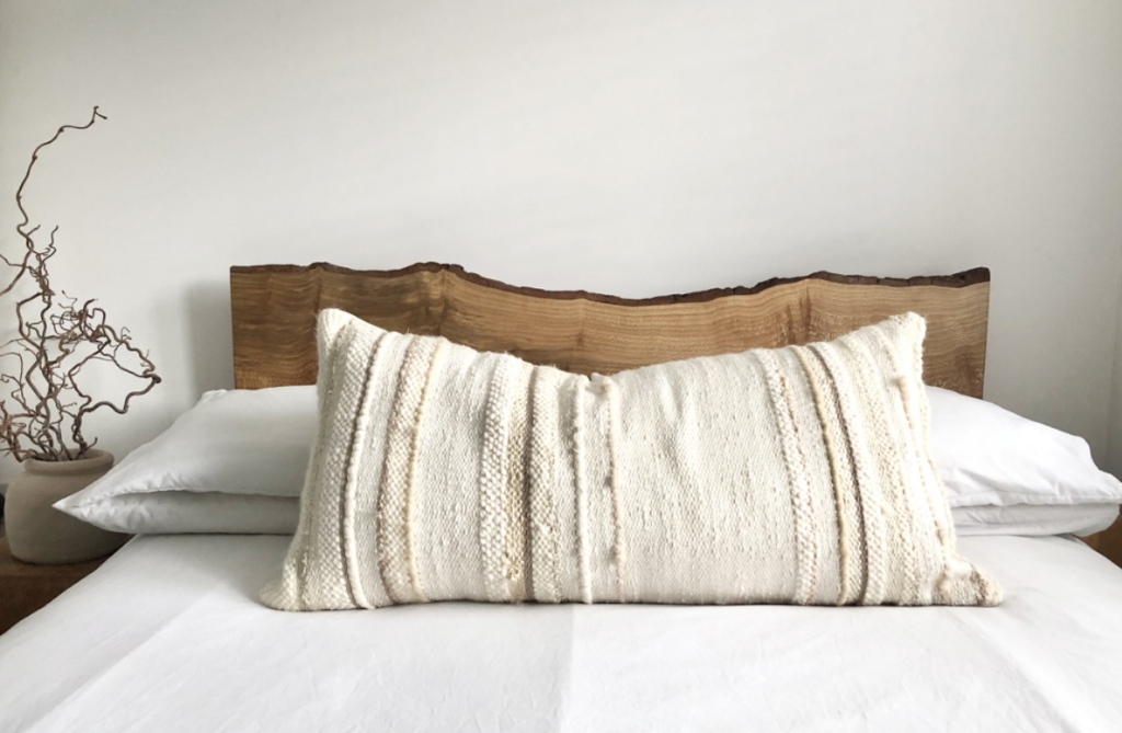 Extra large handwoven bed cushion in creamy shades, using various textured detailing, by Weaveloveamy.