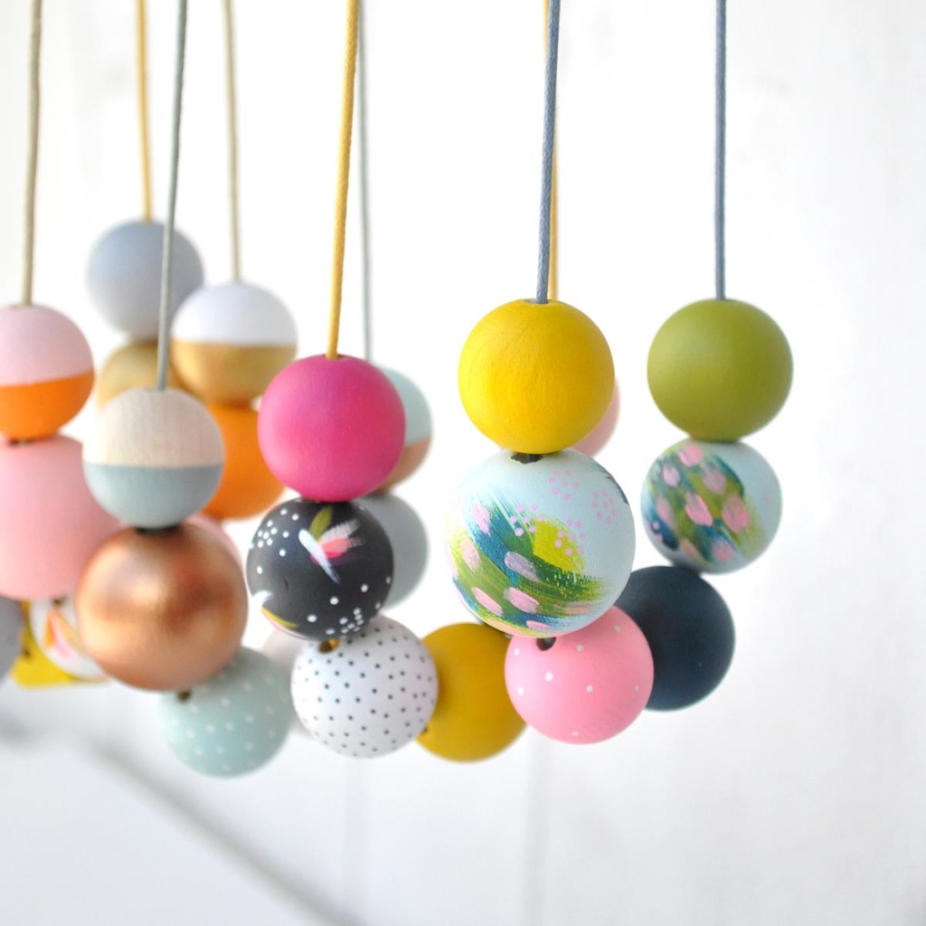 Group of brightly coloured wooden bead necklaces inspired by Cornish shades, by Sea Pink Studio.