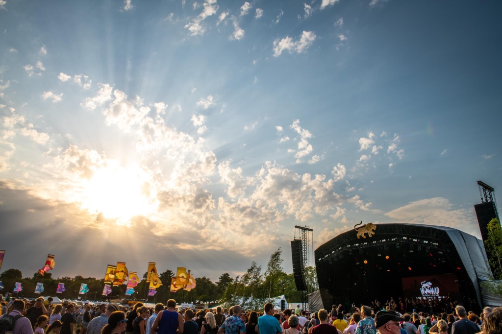 WOMAD Festival - early evening audience at Open Air Stage, with flags.