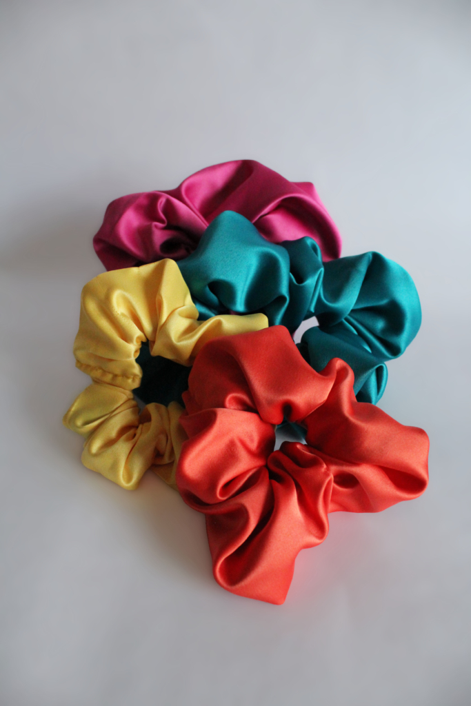 silky scrunchies in various bright colours, by Adina Monette