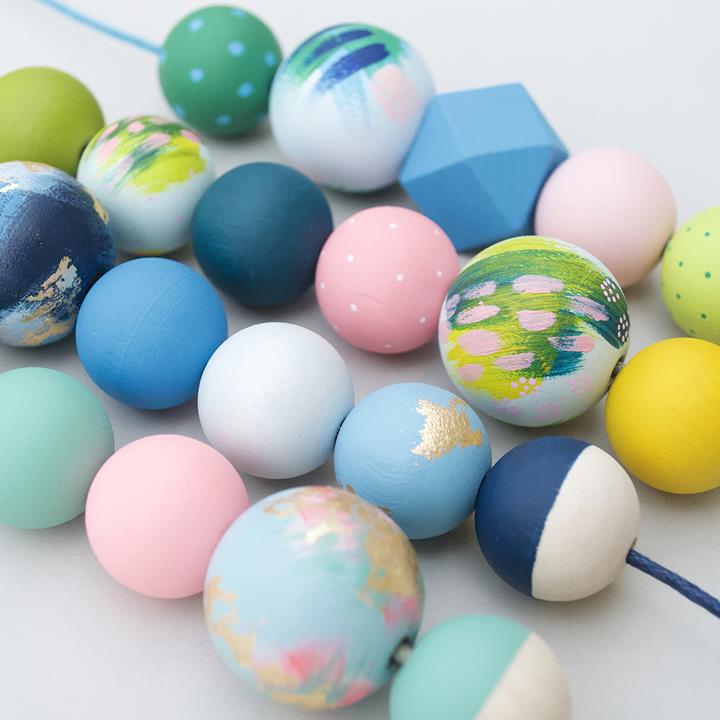 Large round wooden beads in brightly painted beach and ice cream shades. Made of sustainable wood, by Sea Pink Studio.
