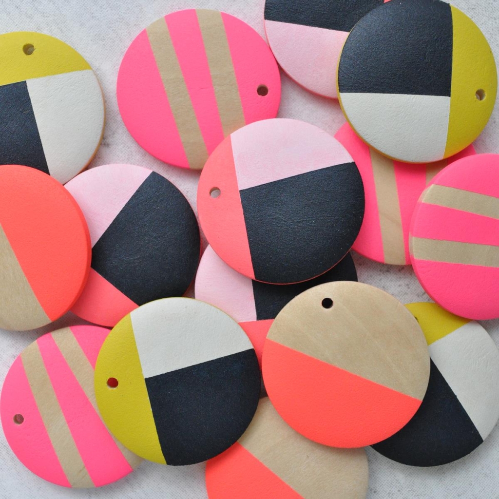 Beads for disc shaped drop earrings in shades of bright yellow, pink, orange and black. Made of sustainable painted wood, by Sea Pink Studio.