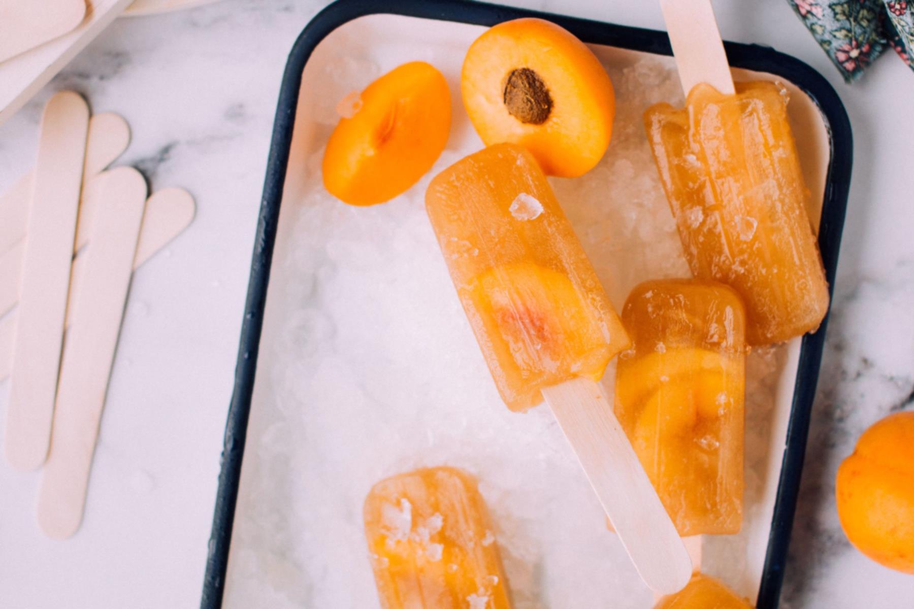 ice lollies made with frozen peaches and peach juice