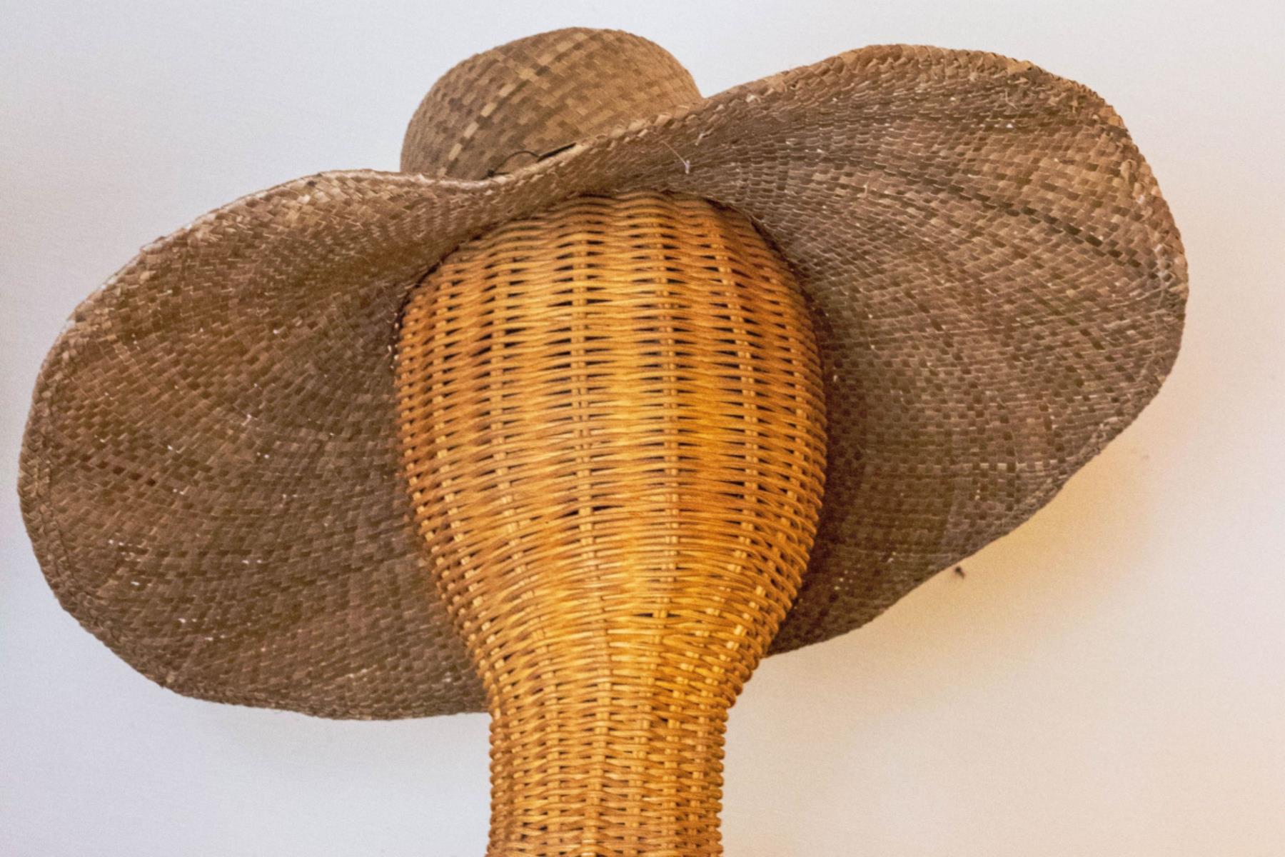big straw sun hat on a mannequin head
