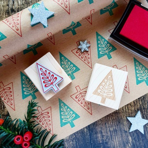 Christmas tree stamp, with brown wrapping paper stamped with Christmas tree motifs