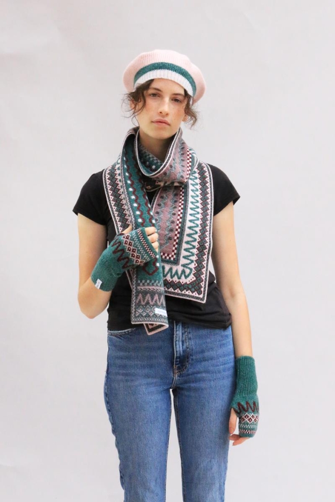 Model wearing 'Blockley' scarf in shades of mushroom and jade green, a wide woollen scarf.