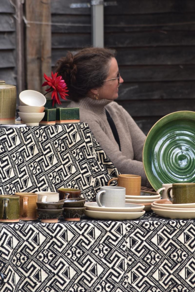 Cornelius Ceramics stall at Windmill Hill Market - a display of earthy coloured mugs and plates.